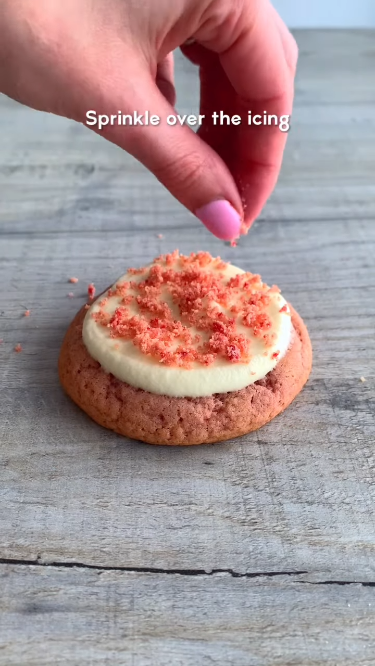 Making crumb topping: combining crushed shortbread cookies, strawberry Jell-O powder, and melted butter in a glass bowl. 