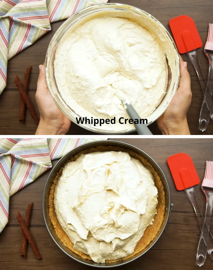 Hands holding a bowl filled with creamy pumpkin cheesecake filling, with kitchen tools and cinnamon sticks on a wooden table.